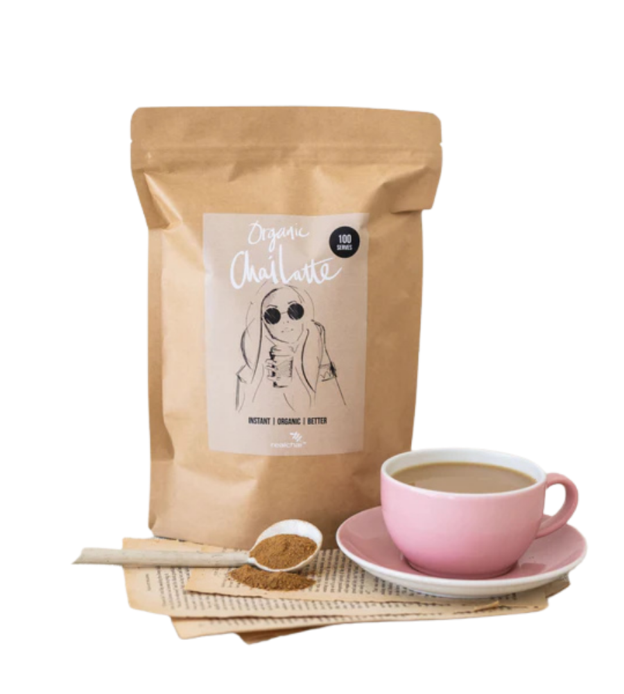 Image of real chai spice powder with cup of chai latte